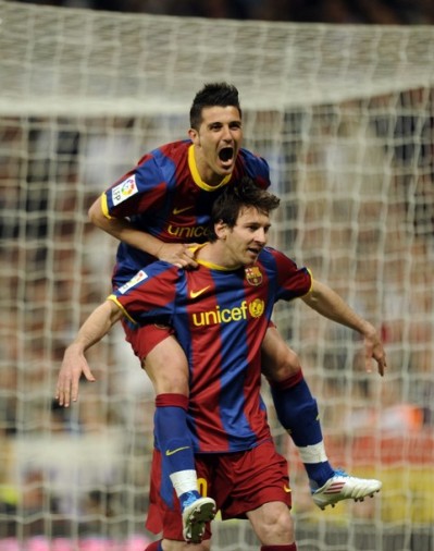  Messi down and Barcelona s forward David Villa celebrate after scoring 